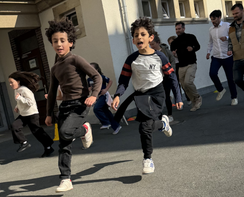 Zwei Jungs rennen auf dem Schulhof
